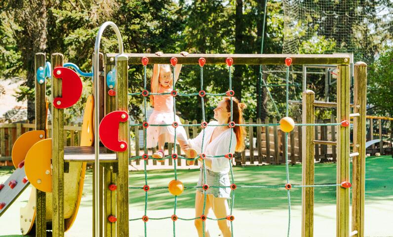 Children playing in the playground at Camping Le Séquoïa