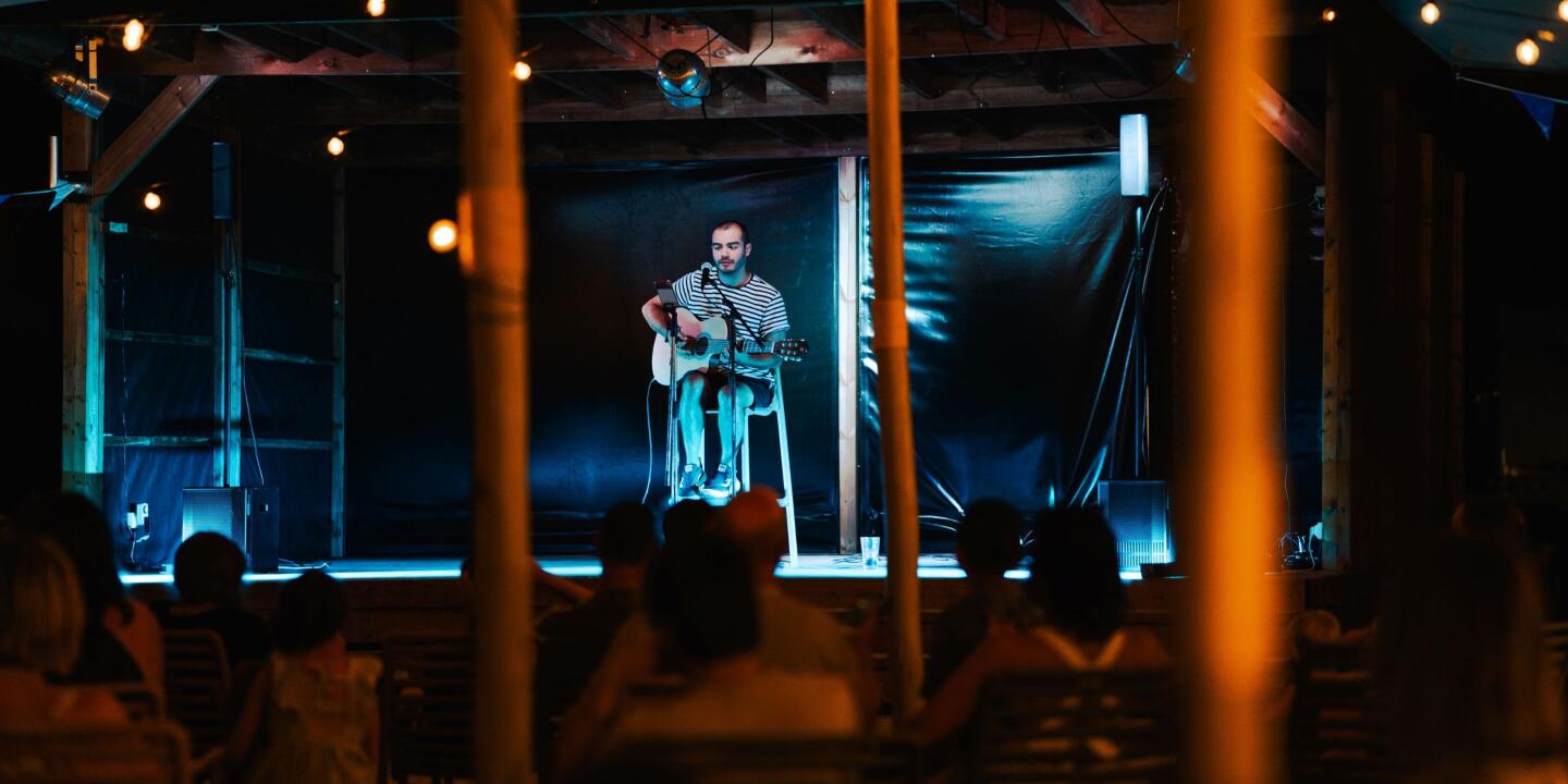 Jules Rey, creator of the Sunêlia song, performing at the campsite